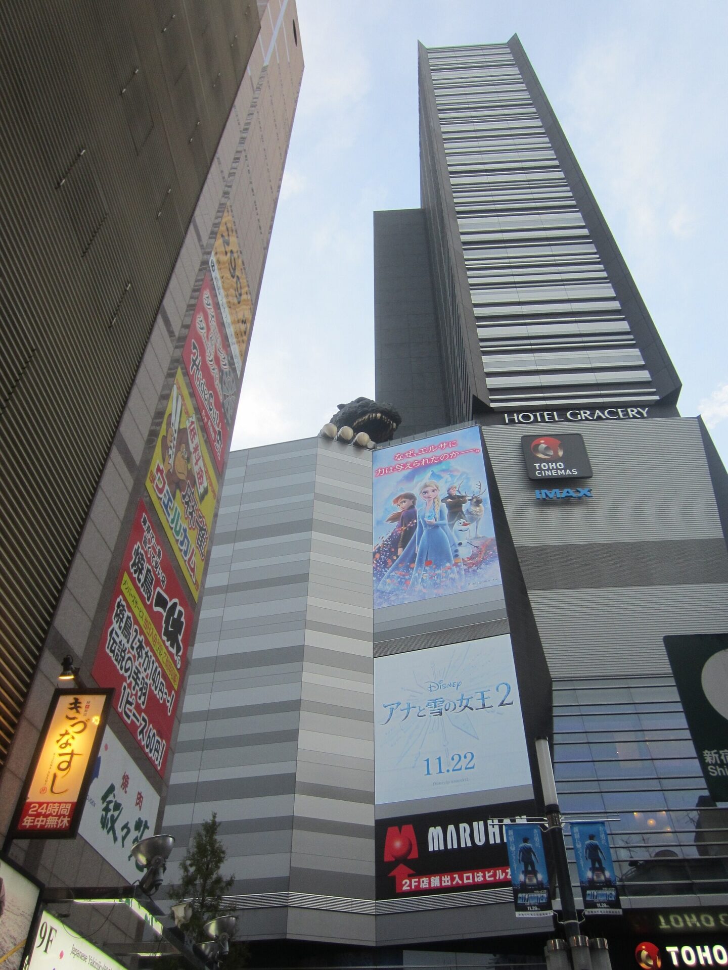 格拉斯麗新宿酒店的外觀,建築中段露台上有哥吉拉的頭,牆面掛著 HOTEL GRACERY 招牌。